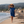 Femme a la plage portant un poncho leger en coton biologique coloris outremer - Atelier Dune